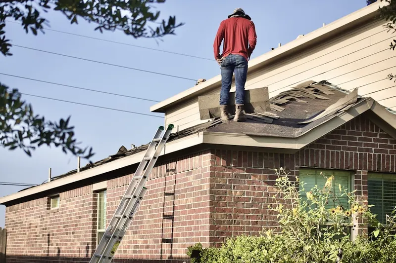 Professional roofer working on a residential roof in Township Of Washington